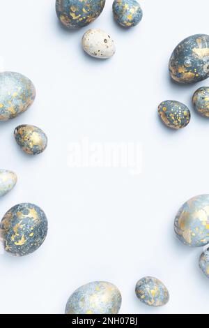 Blue Easter eggs frame. Light Easter background or elegant greeting card, copy space. Stock Photo