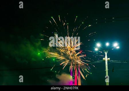 Beautiful multi-colored fireworks against the background of the night sky. High quality photo Stock Photo