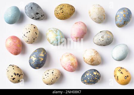 Dyed colorful pastel Easter eggs pattern on white background. Easter greeting card. Stock Photo
