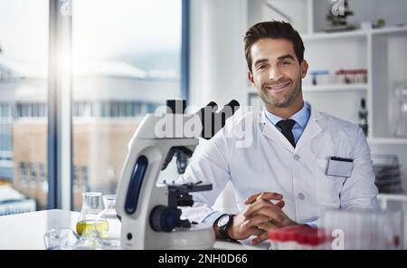 My job is to make sense of the world through science. Portrait of a scientist working in a lab. Stock Photo