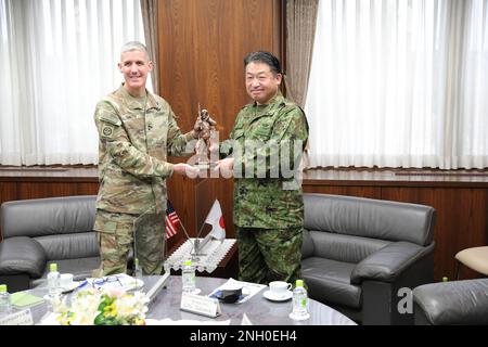 Maj. Gen. Stephen G. Smith, 7th Infantry Division commanding General, presents Lt. Gen. Ryoji Takemoto, Japan Ground Self Defense Force (JGSDF) Western Army Commander with a gift representing continued partnership and mutual trust during Yama Sakura 83 at Camp Kengun, Japan, Dec 4, 2022. Yama Sakura is a complex exercise that has been ongoing for over 40 years and builds the bilateral partnership of the US-Japan alliance. Stock Photo