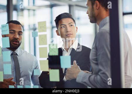 Behind a great plan is a great brainstorming session. a group of young businesspeople having a brainstorming session together in a modern office. Stock Photo