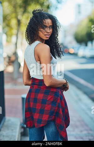 Walking the streets my way. an attractive young woman in the city. Stock Photo