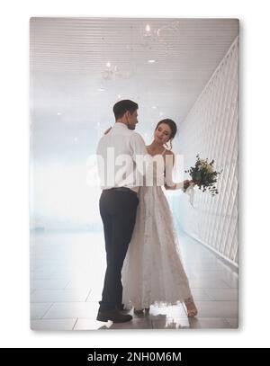 Photo printed on canvas, white background. Happy newlywed couple dancing together in festive hall Stock Photo
