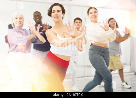 Young Hispanic woman practicing vigorous dance movements Stock Photo