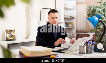 Angry male manager experiencing emotions in office Stock Photo