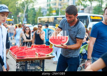 ISTANBUL,TURKEY-JUNE 7:Guys slicing watermelon to sell at their