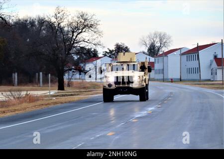 Personnel drive a Joint Light Tactical Vehicle (JLTV) through the cantonment area Dec. 5, 2022, at Fort McCoy, Wis. The Joint Light Tactical Vehicle (JLTV) is designed to restore payload and performance that were traded from light tactical vehicles to add protection in recent conflict, according to the Army. JLTVs give service members more options in a protected mobility solution that is also the first vehicle purpose-built for modern battlefield networks. JLTV operator training at Fort McCoy began in May 2019. Stock Photo