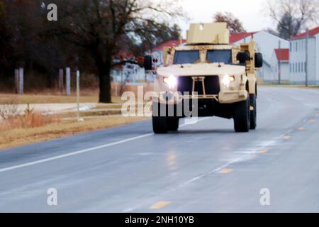 Personnel drive a Joint Light Tactical Vehicle (JLTV) through the cantonment area Dec. 5, 2022, at Fort McCoy, Wis. The Joint Light Tactical Vehicle (JLTV) is designed to restore payload and performance that were traded from light tactical vehicles to add protection in recent conflict, according to the Army. JLTVs give service members more options in a protected mobility solution that is also the first vehicle purpose-built for modern battlefield networks. JLTV operator training at Fort McCoy began in May 2019. Stock Photo