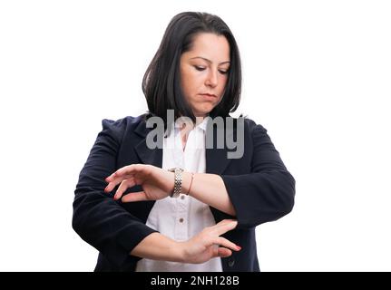 Adult businesswoman touching suit sleeve checking time by looking at wristwatch as corporate concept isolated on white studio background Stock Photo