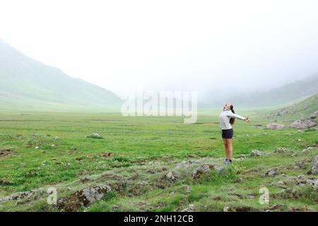 Happy hiker in the mountain celebrating vacation Stock Photo