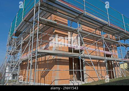 Massive home in shell construction with scaffolding Stock Photo