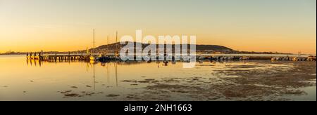 Sunrise on the Etang de Thau, in Balaruc-les-Bains, and Sete in the background, Occitanie, France. Stock Photo