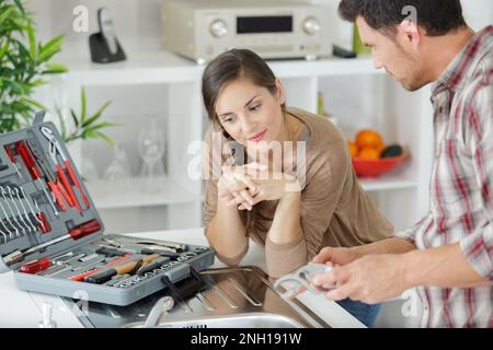 woman with contractor at kitchen discussing repair Stock Photo