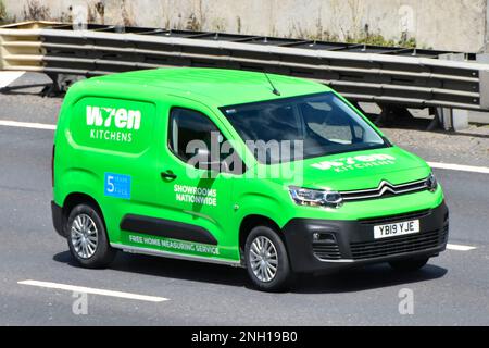 Wren Kitchens supply and fit joinery business operative inside front & side view green Citroen van driving along M25 motorway road in Essex England UK Stock Photo
