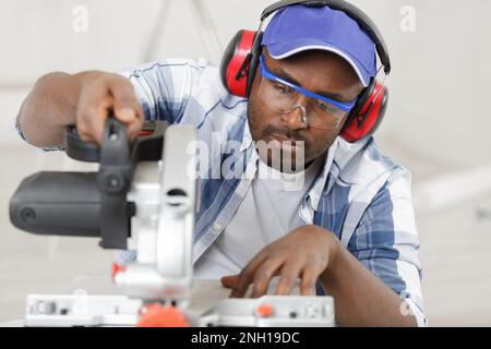 carpenter working on buzz saw Stock Photo