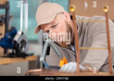 young man working on copper pipes Stock Photo