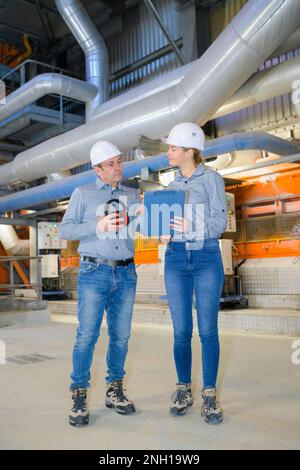 factory and industrial engineers having a conversation Stock Photo