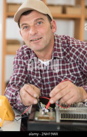man working with cables while looking at the camera Stock Photo