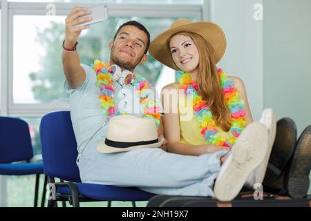 couple tourist taking a selfie in airport before journey Stock Photo