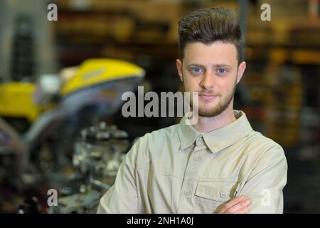 portrait of young caucasian man in garage Stock Photo