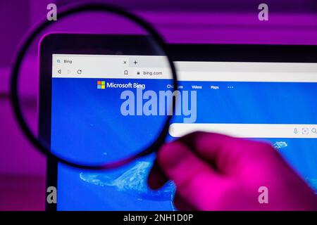 Microsoft Bing chatbot through magnifying glass on screen Stock Photo