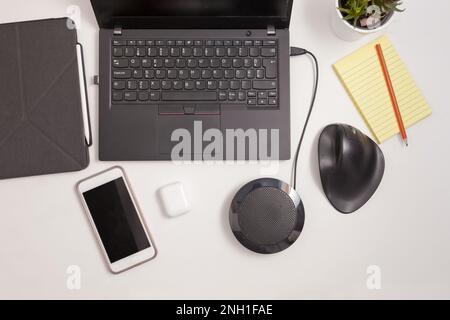 workplace with ergonomic mouse, mobile phone, headphones, column and laptop computer notebook tablet Stock Photo