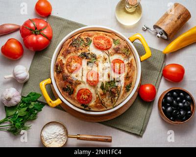 homemade bread in a round shape with vegetables. focaccia art. Stock Photo