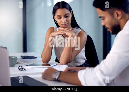 Im going to send these off today. two work colleagues reading over some documents together. Stock Photo