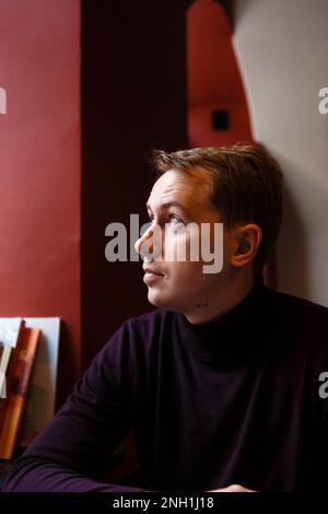 young man sits alone at cafe Stock Photo