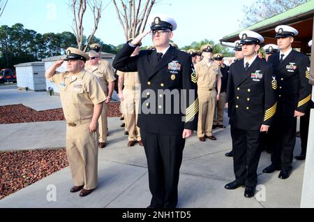 PENSACOLA, Fla. -- Members of the Pensacola Area Chief Petty Officer Association (PACPOA) salute during morning colors at the Pearl Harbor Remembrance Ceremony at Barrancas National Cemetery onboard Naval Air Station (NAS) Pensacola, Fla. The event was designed to honor the 2,403 sailors, soldiers and civilians killed and estimated 1,000 wounded during the Japanese attack on Pearl Harbor Dec. 7, 1941. The attack also crippled or destroyed nearly American ships and more than 300 airplanes, and destroyed dry docks and airfields. Stock Photo