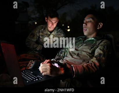 U.S. Air Force Senior Airman William Rosado, 1st Combat Camera Squadron combat camera journeyman, and Staff Sgt. Aaron Irvin, 1st CTCS combat camera craftsman, edit images during Exercise Green Goblin at Joint Base Charleston, South Carolina, Dec. 7, 2022. This four-day exercise provides relevant and essential night-vision training to prepare combat camera Airmen with enhanced photographic and video capabilities required to capture imagery in low-light and no-light environments. Stock Photo