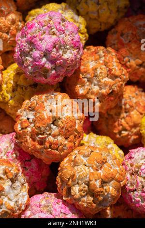 Closeup view of colorful orange pink and yellow popcorn balls on a market stall, Hisor, Tajikistan Stock Photo