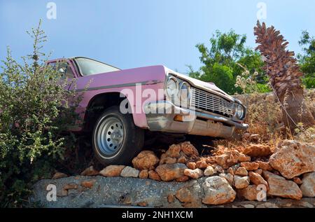 The front half of an old vintage car used as a decoration at the entrance to the Kalkan beach club, Kalkan, Turkey. July 2022 Stock Photo