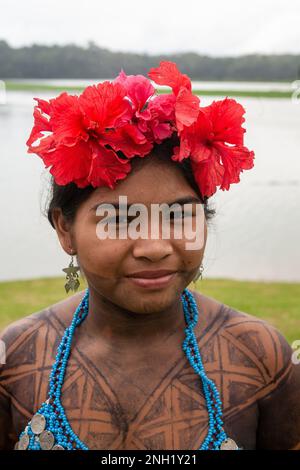 An indigenous Embera woman dressed up for visitors in her village on Lake Alejuela in Panama.  Her body is painted with the juice of the jagua berry t Stock Photo