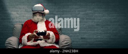 Santa Claus experiencing virtual reality at home and playing videogames using a controller, he is wearing a VR headset Stock Photo