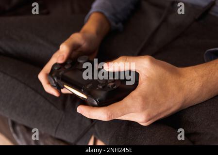 Hands of a boy holding a video game controller up close. Stock Photo