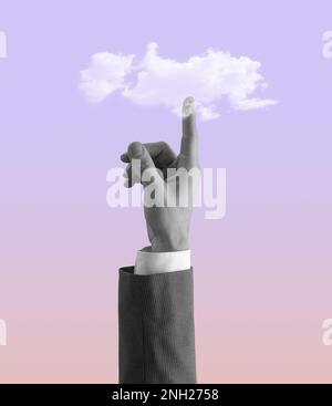 Businessman hand pointing up at the sky and touching a cloud, vintage style design Stock Photo