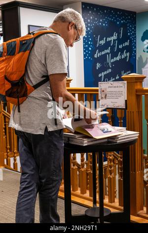 A customer browsing in a Waterstones Bookshop Bookstore. Stock Photo