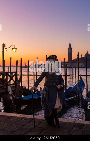 Carnival goer dressed in splendid costume and mask during Venice Carnival 2023 at St Marks Square, Venice, Italy in February Stock Photo