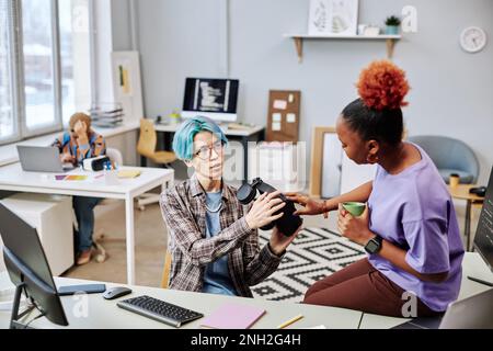Portrait of two young people working on VR software programming in office Stock Photo