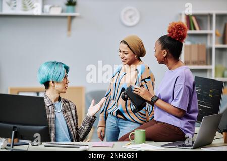 Diverse team of young software developers working on VR programming in office Stock Photo