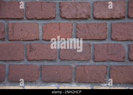 old brick house wall with red and yellow stones Stock Photo