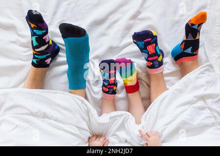 Colorful socks on feet as a symbol of World Down Syndrome Day. Stock Photo