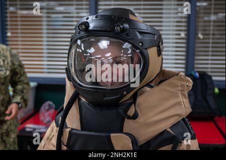 221208-N-WF272-2027 BRICK TOWNSHIP, N.J. (Dec. 8, 2022) A Brick Memorial High School student tries on a bomb suit during a U.S. Navy Explosive Ordnance Disposal (EOD) team educational visit to the school on Dec. 8, 2022. The team, composed of members of EOD Mobile Unit 12, EOD Enlisted Community Management BUPERS-32, Navy Talent Acquisition Group Philadelphia, and Navy Recruiting Command, held interactive training using the bomb disposal-robots, and discussed a variety of EOD and diver opportunities in the service. Stock Photo