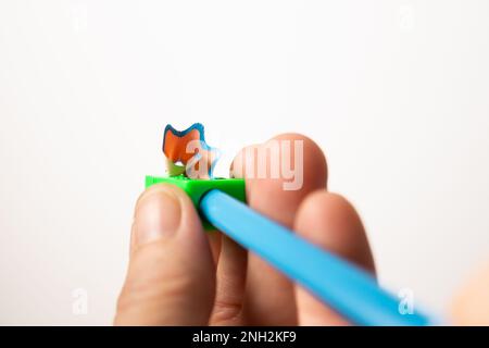 woman's hand with pencil sharpener in white background Stock Photo