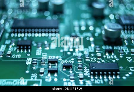Closeup of Printed Circuit Board with processor, integrated circuits and many other surface mounted passive electrical components. Stock Photo