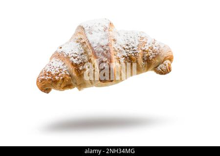 Fresh croissant with sugar floating on white background. Stock Photo