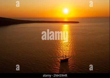 Sunset on the water off the Island of Santorini. Stock Photo