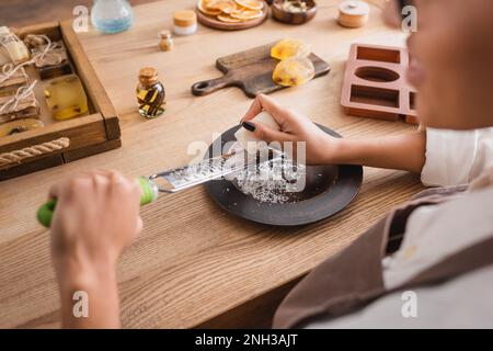 https://l450v.alamy.com/450v/2nh3ajt/partial-view-of-blurred-african-american-woman-with-grater-near-silicone-mold-and-handmade-soap-on-table-in-workshopstock-image-2nh3ajt.jpg